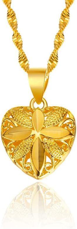 Gold heart-shaped pendant necklace with intricate design on a white background