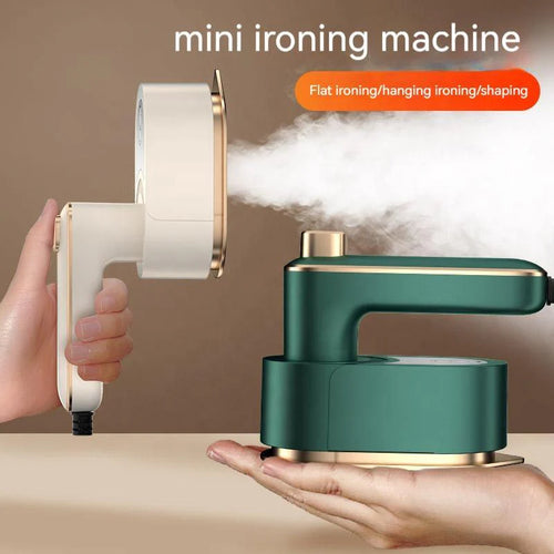 Mini ironing machine with steam being emitted, held by a hand against a beige background.