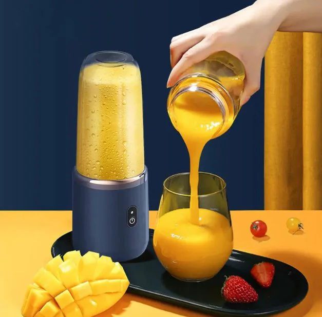 Hand pouring yellow juice from a blender into a glass on a yellow background in kitchen