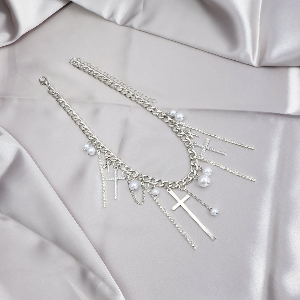 Silver bracelet with charms on a light gray fabric background