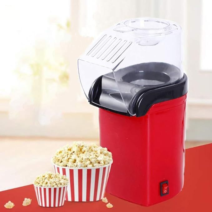 Red popcorn maker with a bowl of popcorn on a red surface