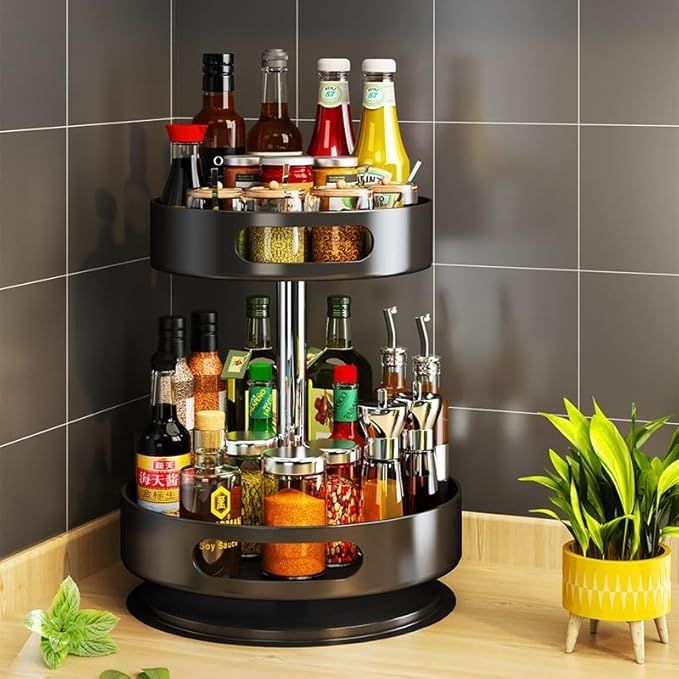 Black tiered spice rack with various condiments on a kitchen counter.