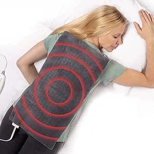Woman using a heating pad on her back with a white background