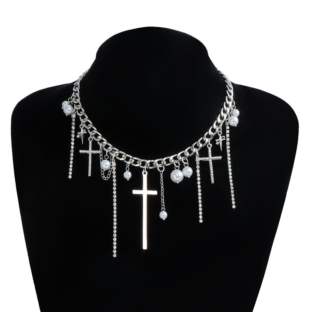 Necklace with cross and pearl pendants on a black mannequin bust.