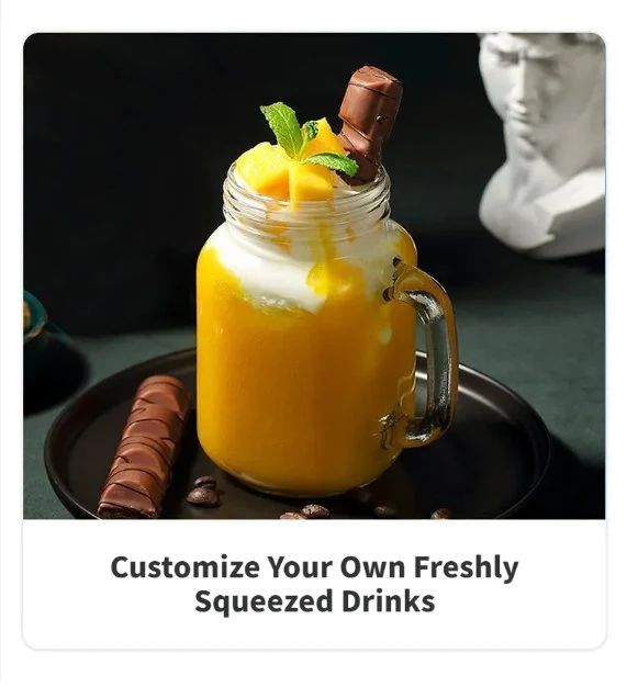 Mason jar with a layered drink, topped with mango pieces and a chocolate bar, on a dark surface kitchen
