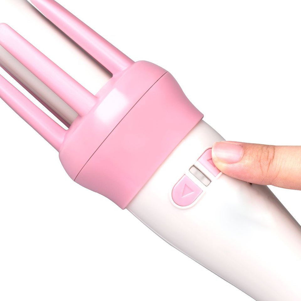 Pink and white hair straightener with a hand pressing a button on a white background hair beauty comb brush