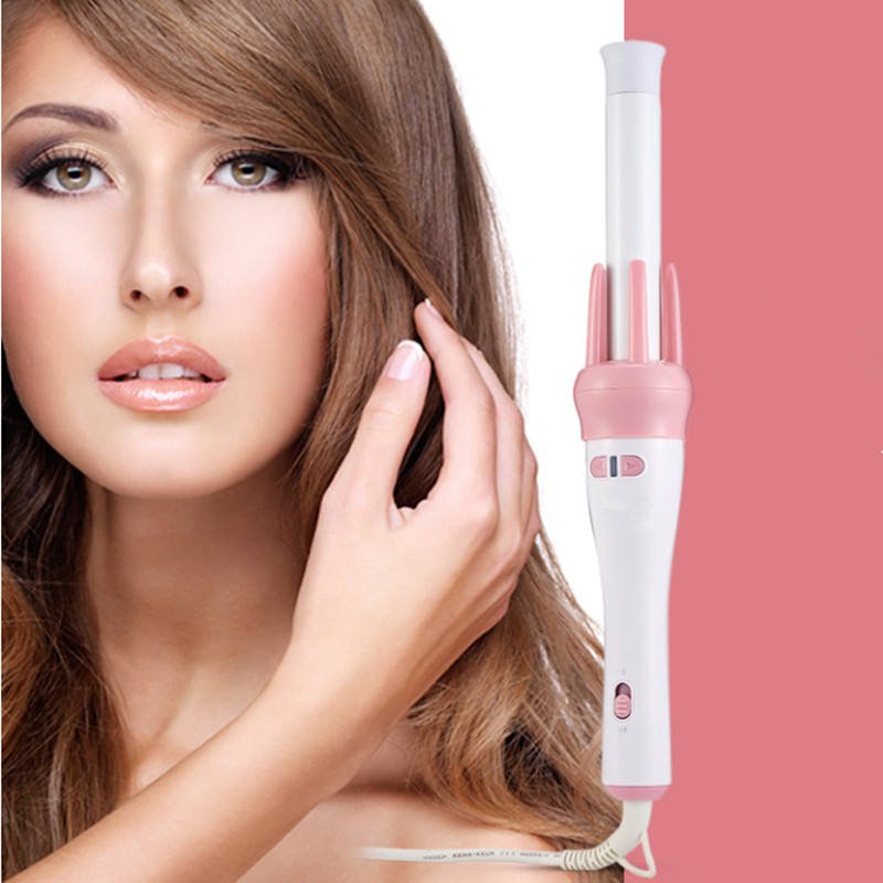 Woman with styled hair and a pink and white hair styling tool on a pink background hair beauty comb brush