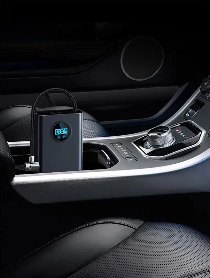 Car charger with digital display inside a car's cup holder. high-pressure air pump